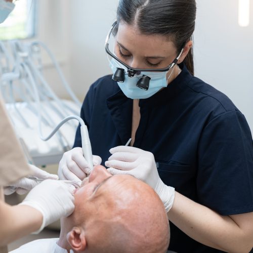 Dentist performing dental procedure